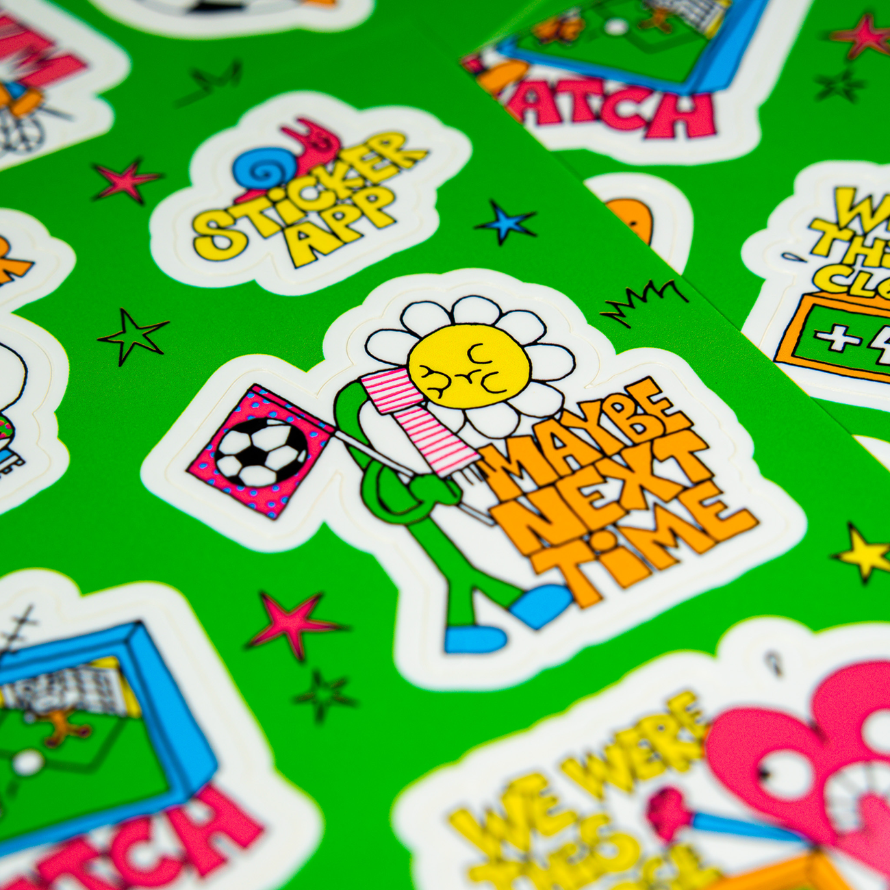 Detail sticker of a football-themed sticker sheet with a green background and colorful cartoon characters.