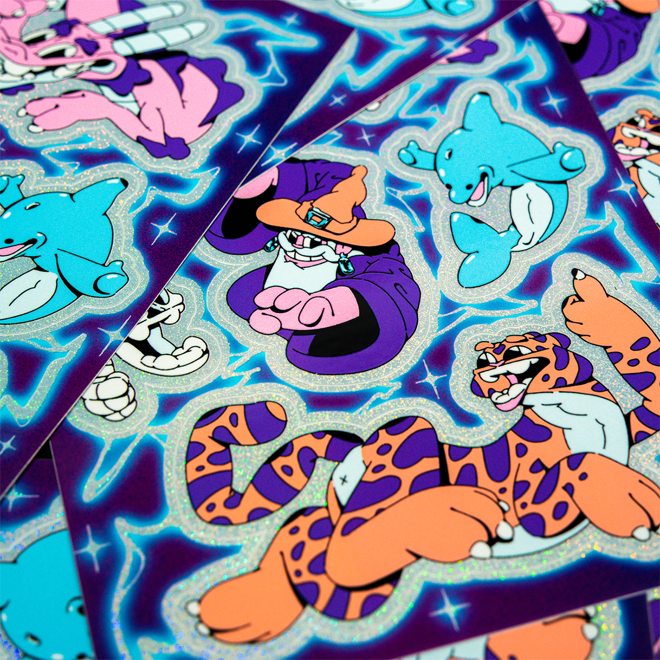 Sticker sheets on top of each other, with cartoon characters of a tiger, dolphin and wizard, printed on Pixie Dust.