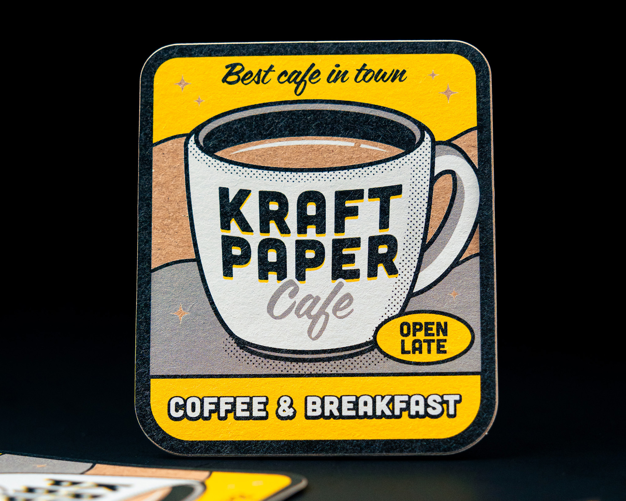 Square sticker with "Kraft Paper Cafe" logo, featuring a coffee cup design, "Best cafe in town," and "Coffee & Breakfast."