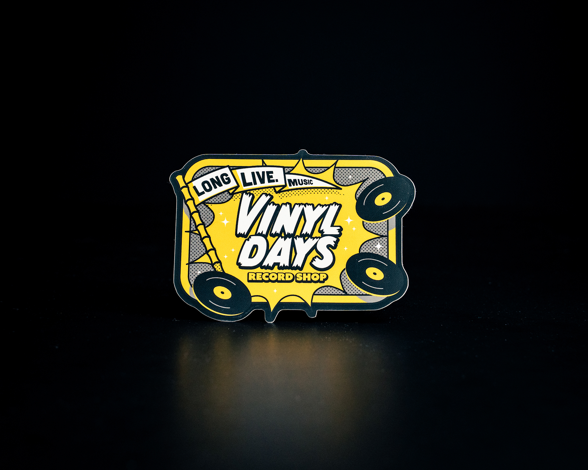 Sticker with "Vinyl Days Record Shop" text, surrounded by vinyl records on a yellow background. Subtext reads "Long Live Music."